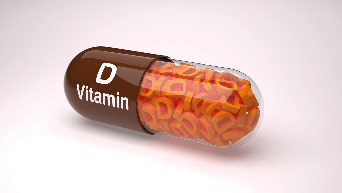 Brown pill or capsule filled with vitamin D.