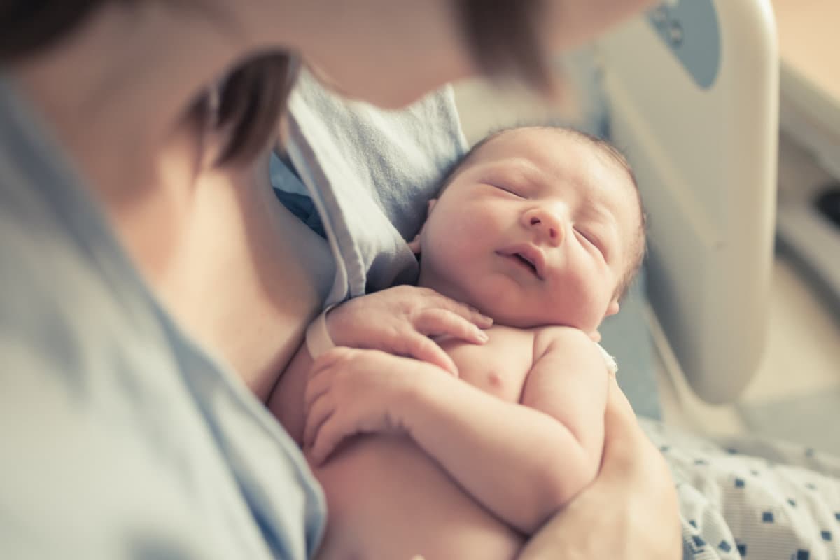 Parenting and new life concept. Mother holding newborn baby boy