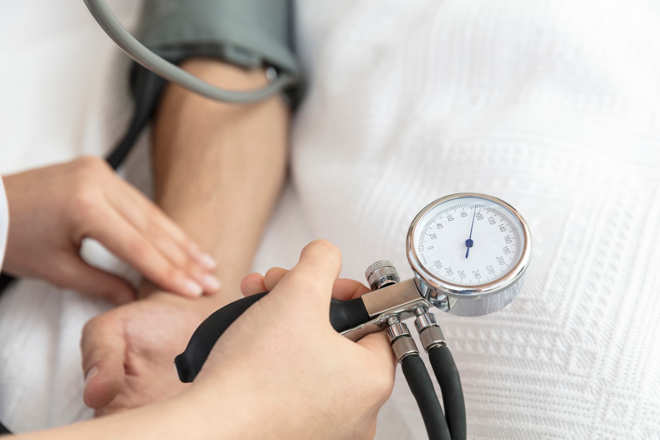 Nurse taking blood pressure of patient