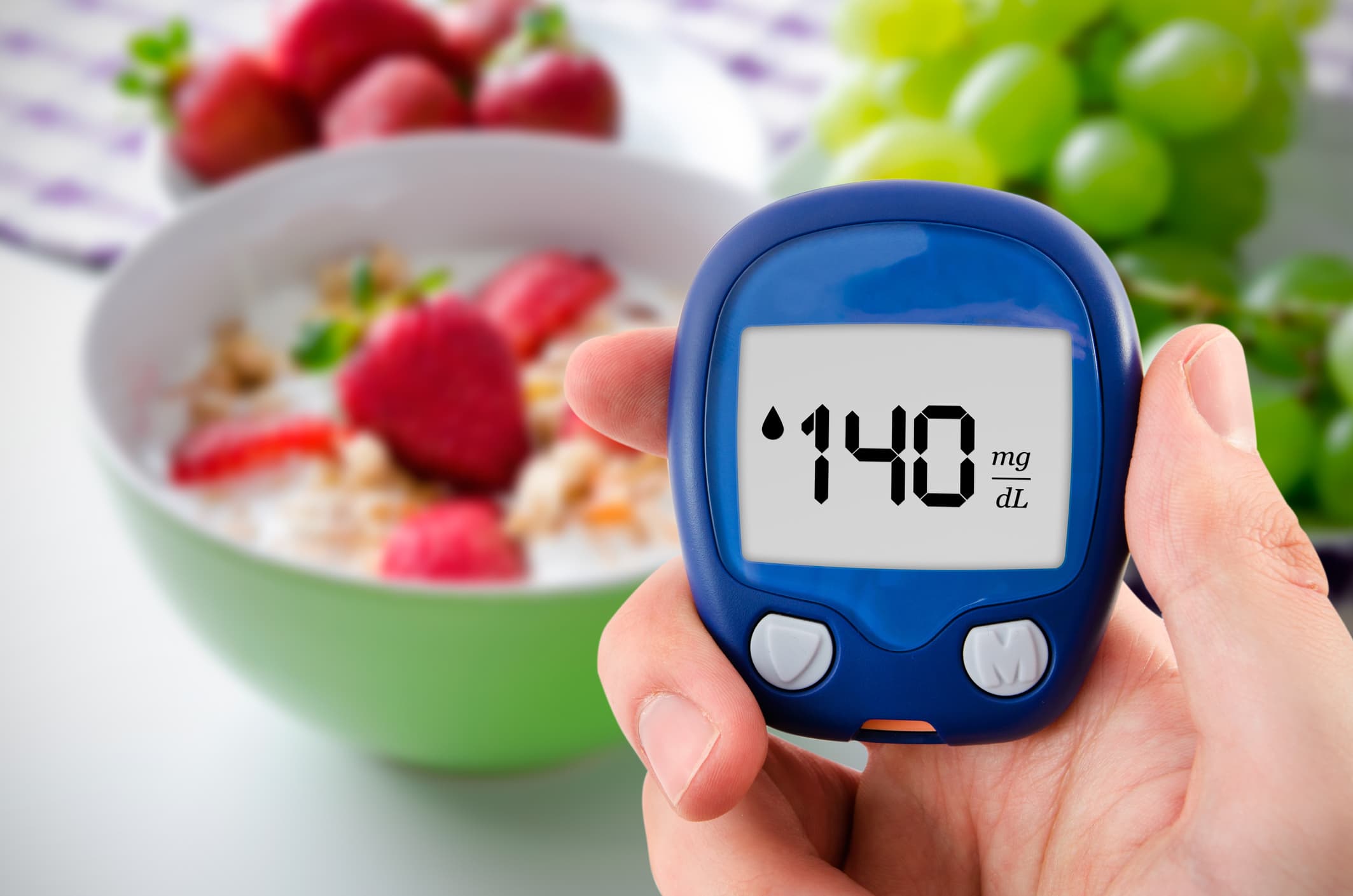 Diabetes doing glucose level test. Fruits in background