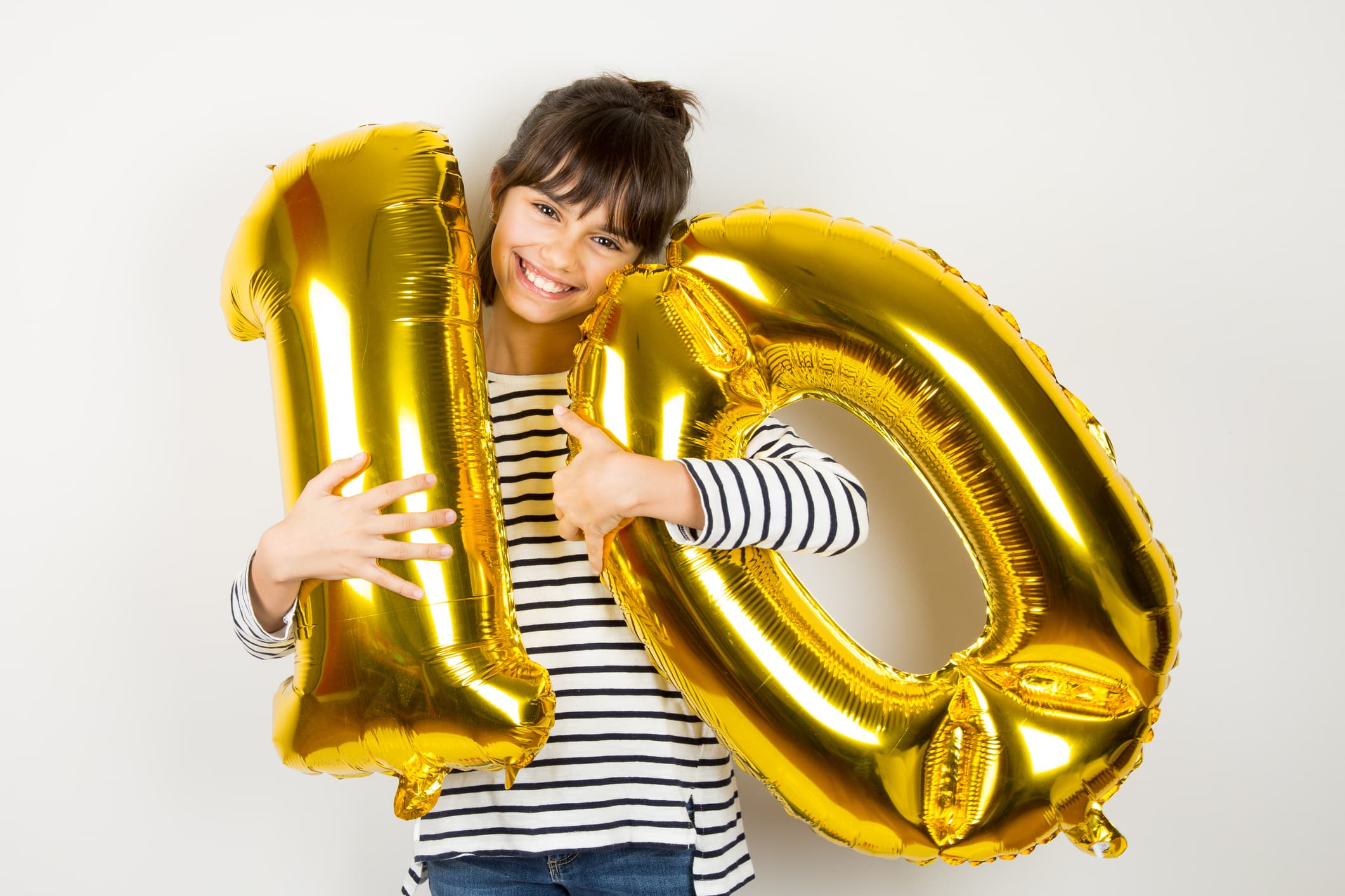 Ten birthday party girl with golden balloons