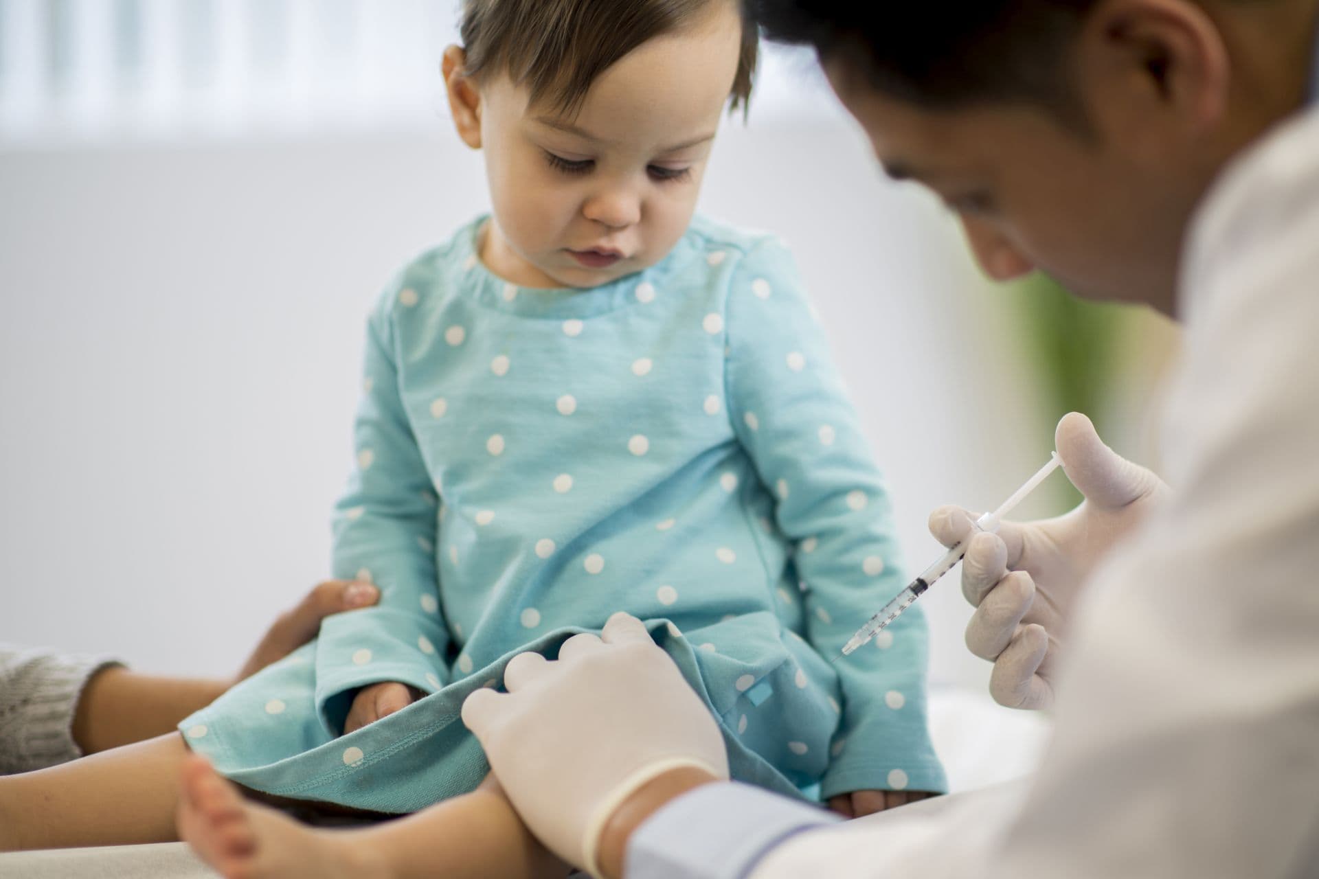 Immunization at the doctors office for a little toddler girl.