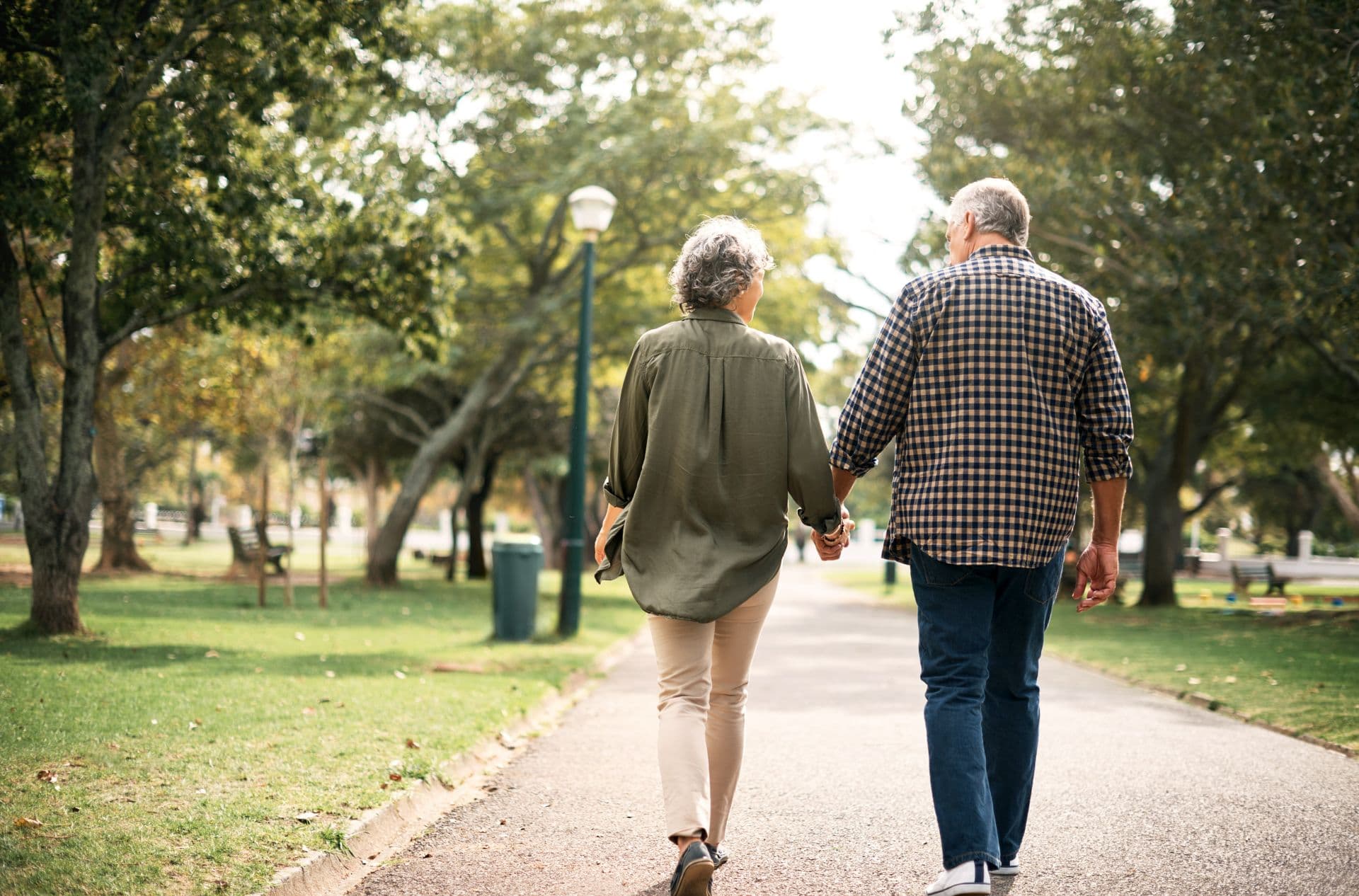 Rearview shot of a senior couple going for a walk in the park