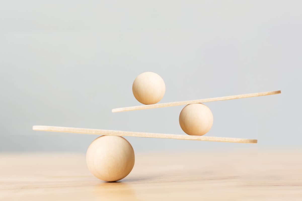 Wooden scale balancing on seesaw. Concept of harmony and balance in life and work