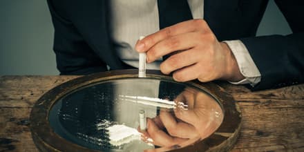 Businessman snorting cocaine