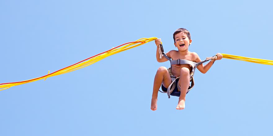 Boy jumping on trampoline