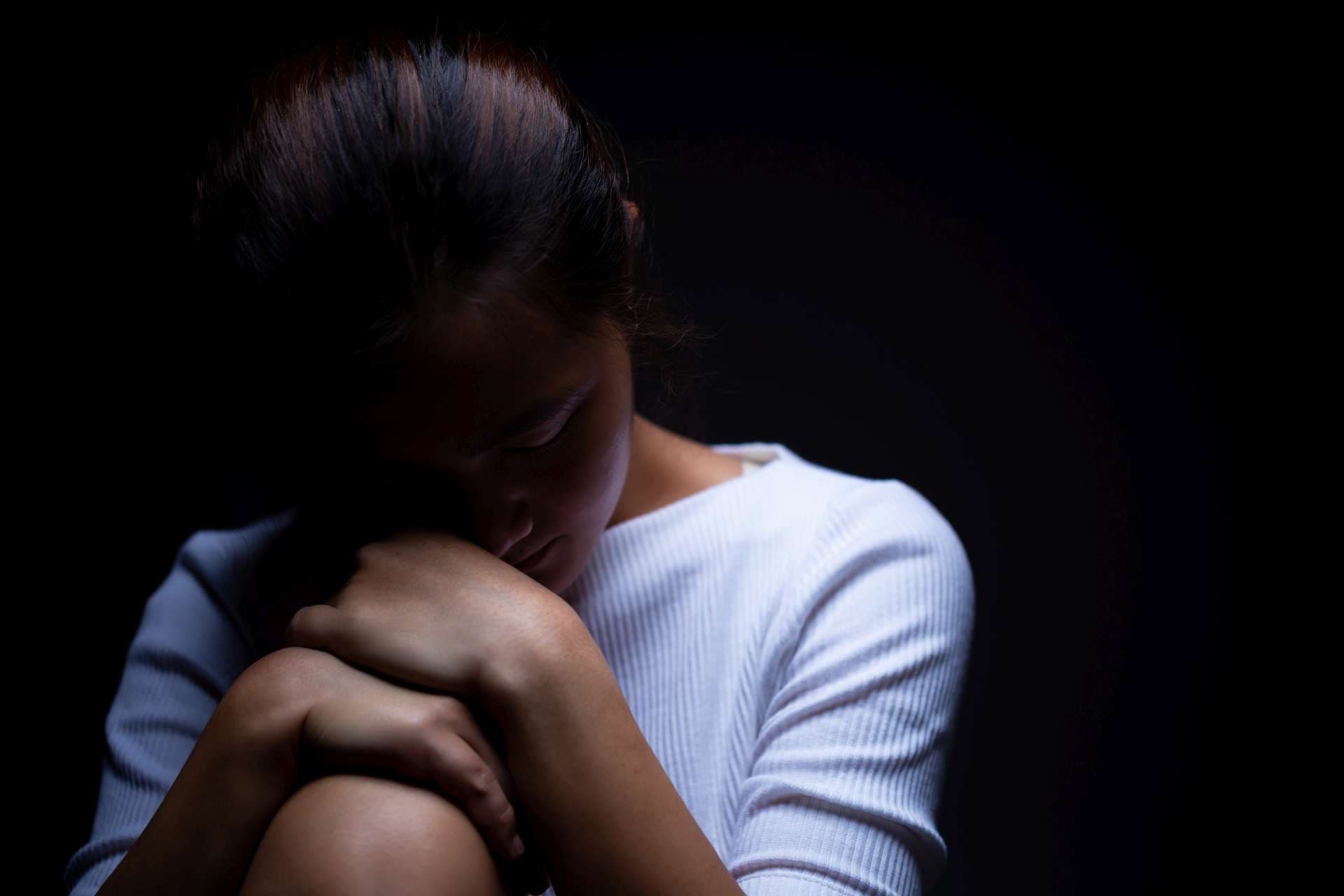 Sadness of a woman in the dark