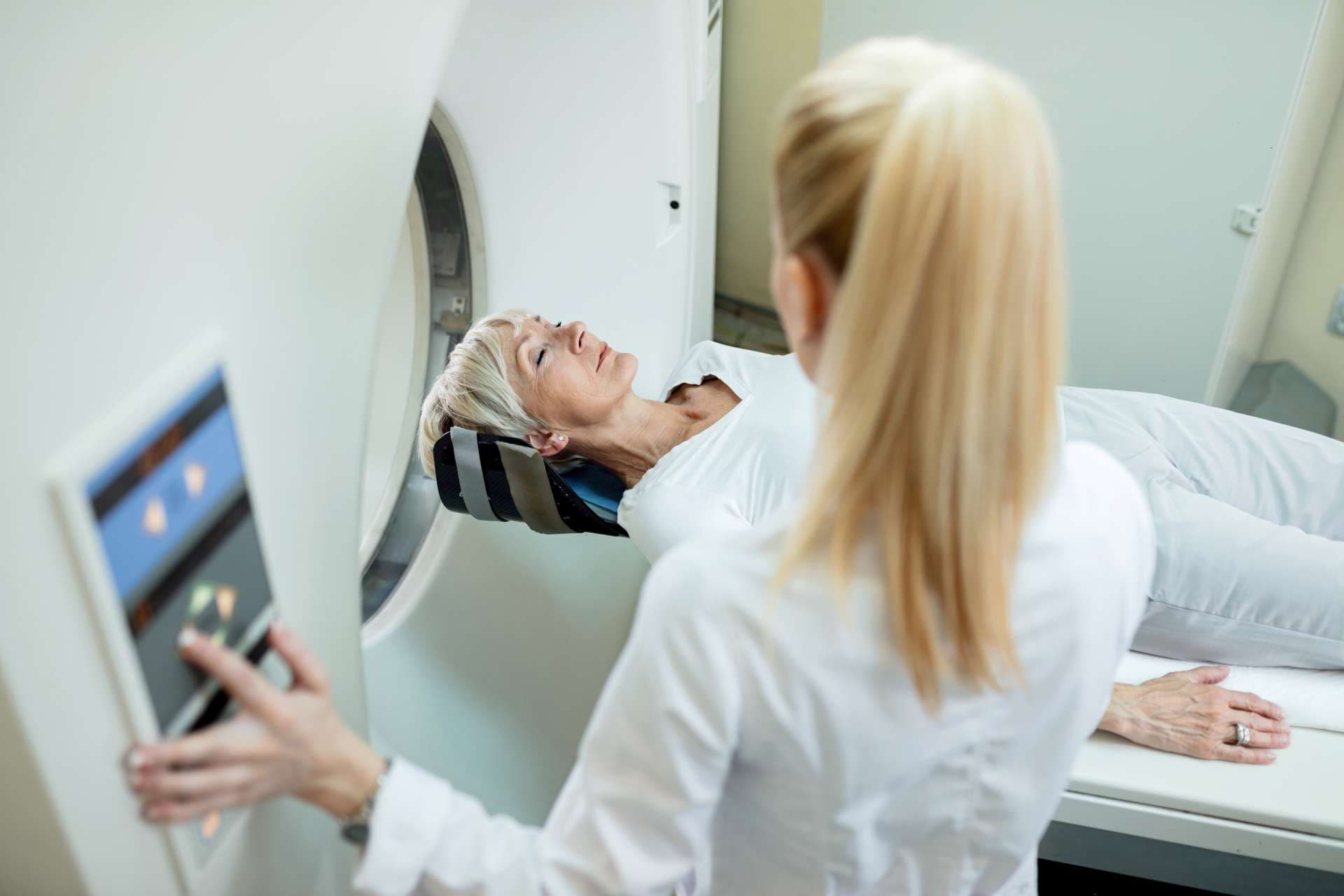 High Angle View der reifen Frau und des Radiologen während der MRT-Untersuchung in der Klinik.