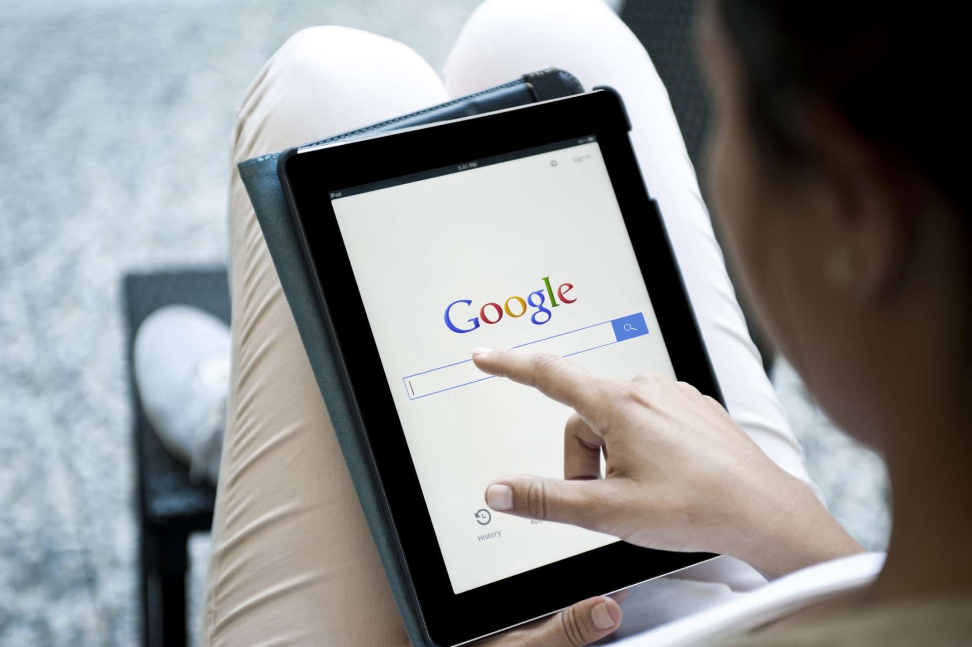 "istanbul, Turkey - July 6, 2012:Hands holding a iPad with Google site.Google Inc. is an American multinational public corporation invested in Internet search, cloud computing, and advertising technologies. iPad produces by Google."