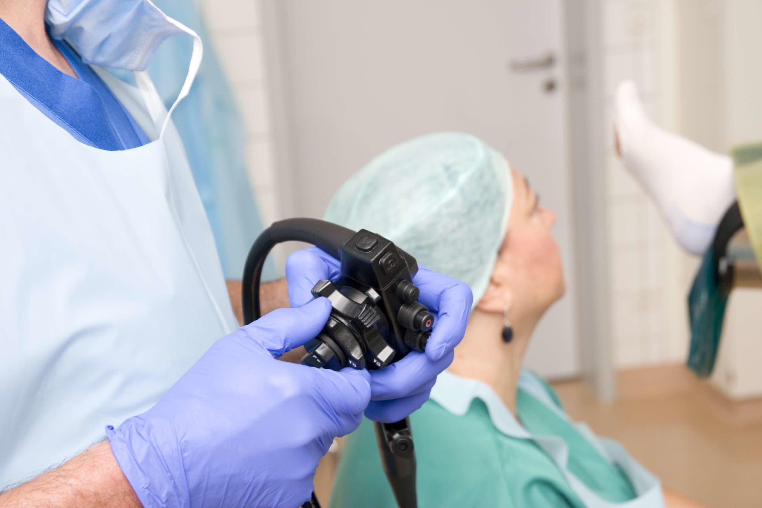 "Close-up of the controls of a colonoscope. This instrument is used for performing colonoscopies, or polyp removal. Progress monitored by surgeon and assistant on computer screen, the patient is under general anesthesia. Selective focus, shallow depth of field."