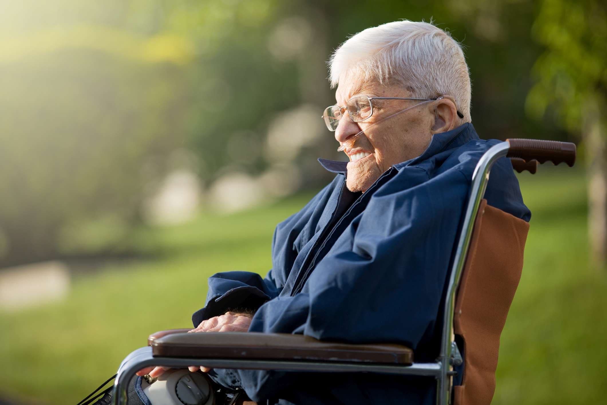 Ein 92 Jahre alter Mann sitzt in seinem Rollstuhl und genießt die Abendsonne.