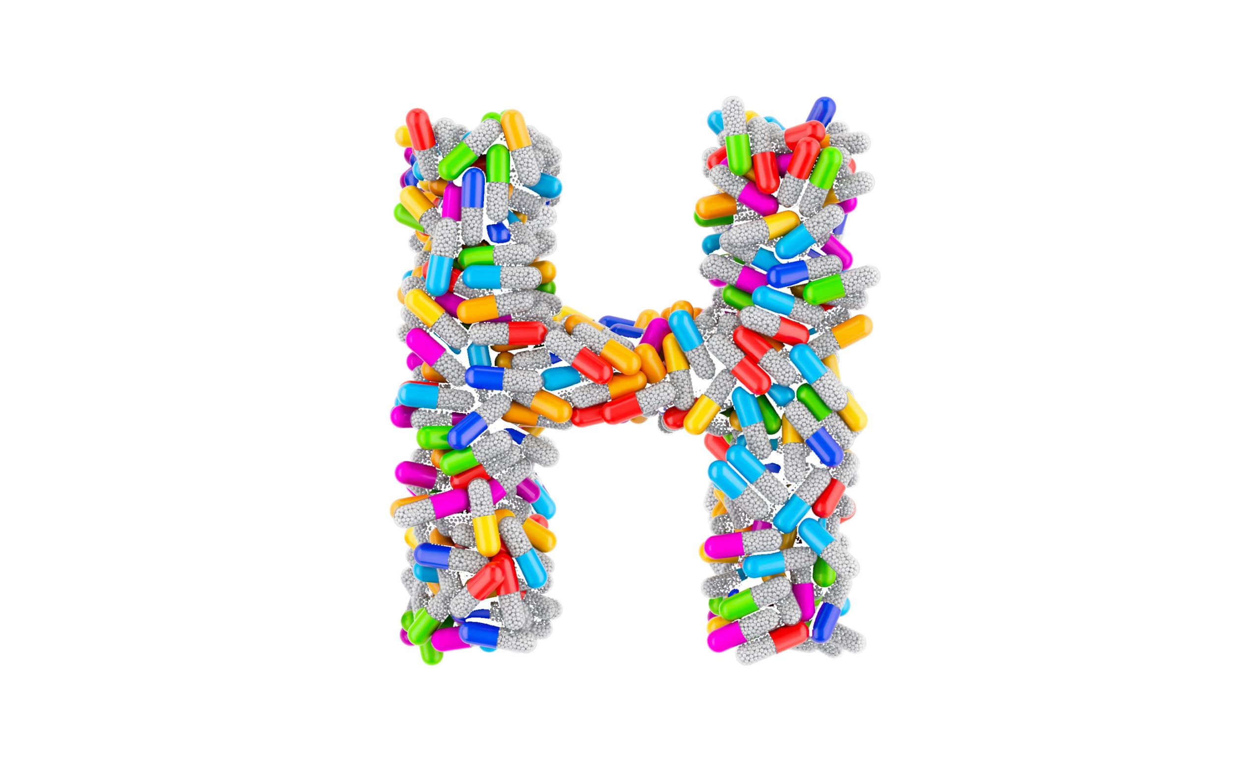 Tabletten in H-Form vor weißem Hintergrund