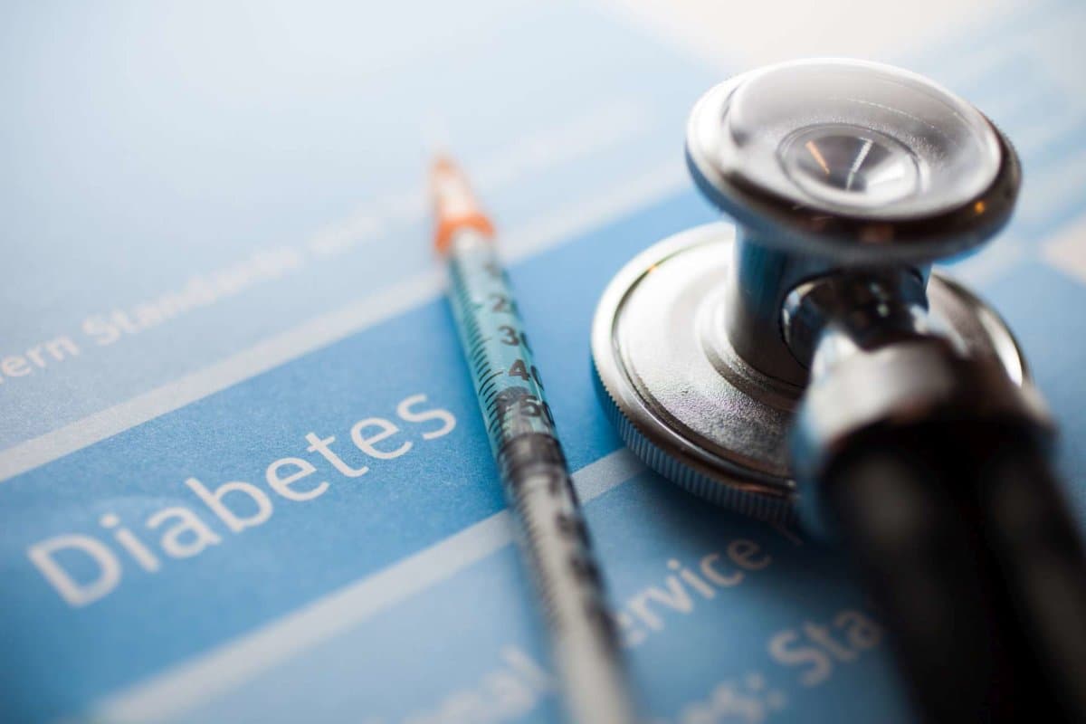 Stethoscope and a syringe on a diabetes test