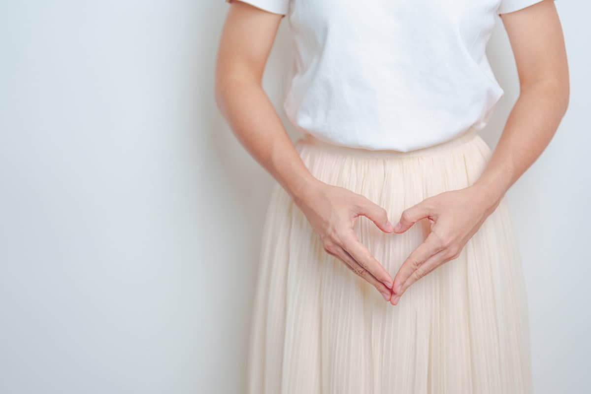 Woman hand heart shape over abdomen. Ovarian and Cervical cancer, Endometriosis, Hysterectomy, Uterine fibroids, Reproductive, menstruation, Stomach, Pregnancy and Sexual Transmitted disease concept