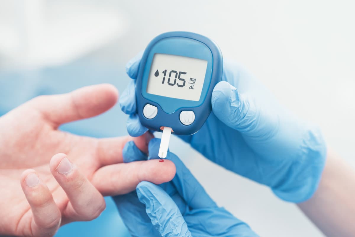 Doctor checking blood sugar level with glucometer. Treatment of diabetes concept.