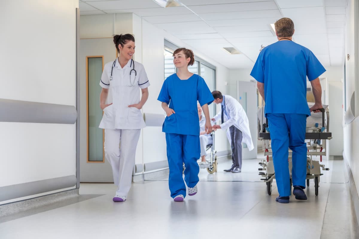 Doctors Hospital Corridor Nurse Pushing Gurney Stretcher Bed