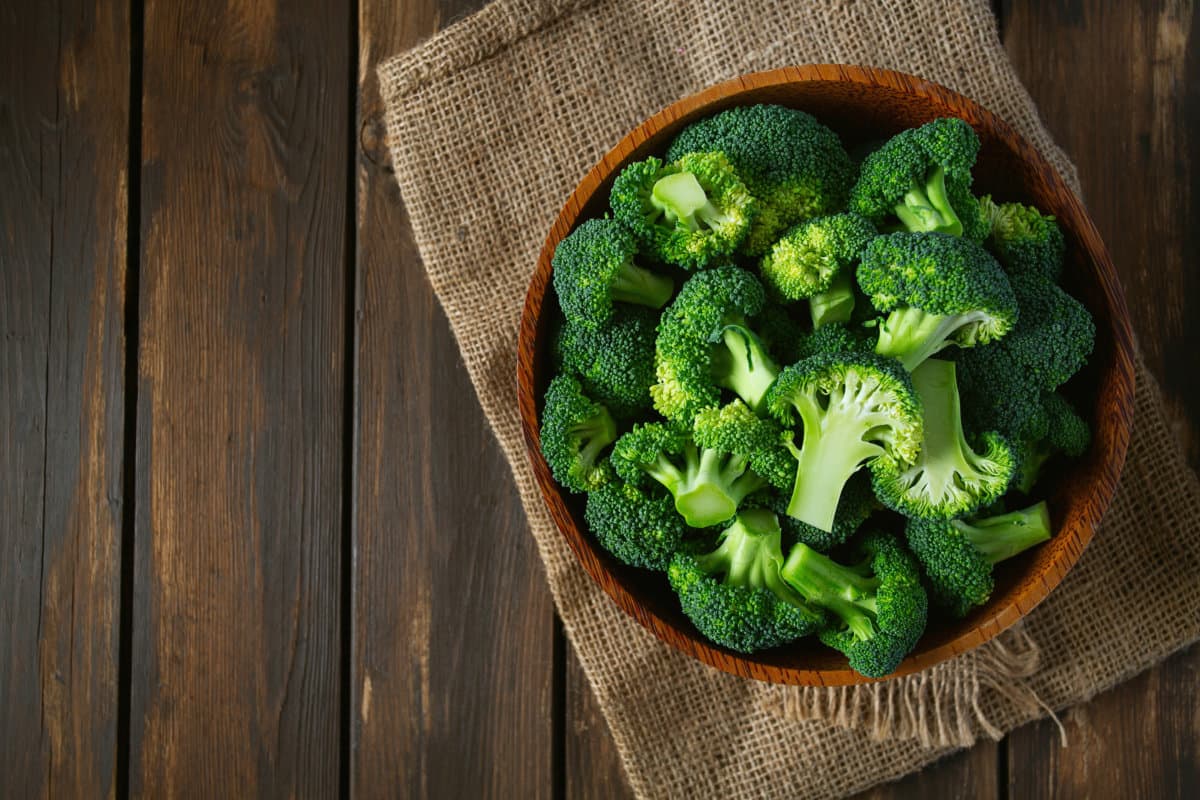 fresh broccoli on wooden surface