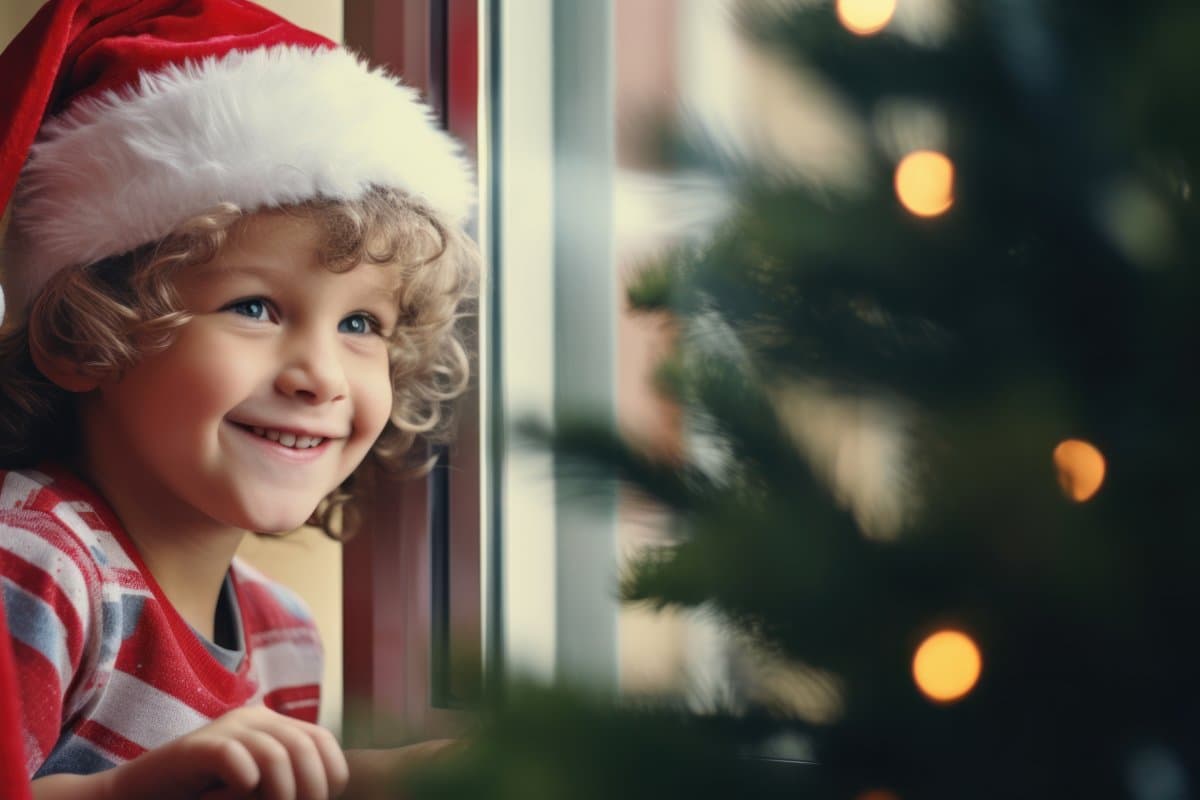 Cheerful Kid Dressed as Santa Claus with Mini Christmas Tree, Spreading Holiday Joy on Christmas Morning