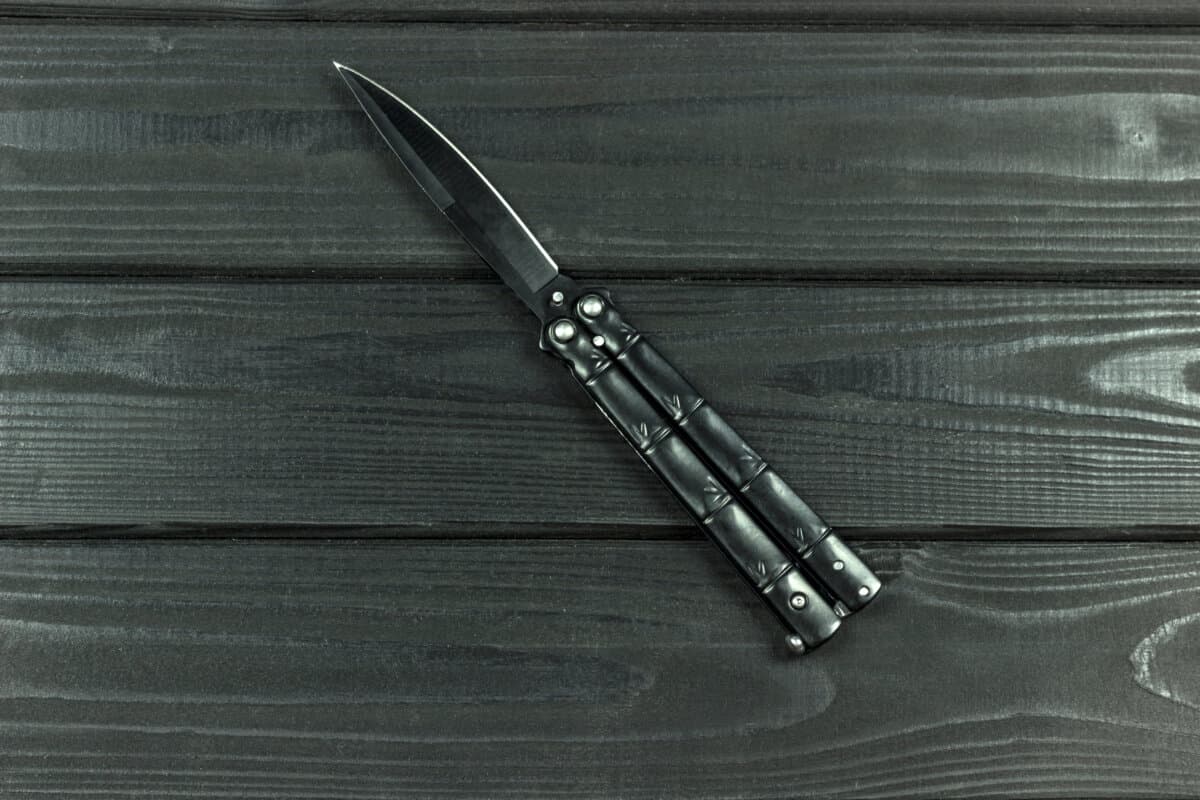 butterfly knife on a wooden background