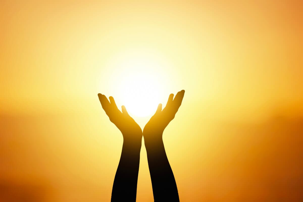 silhouette of man both hands and sunset light