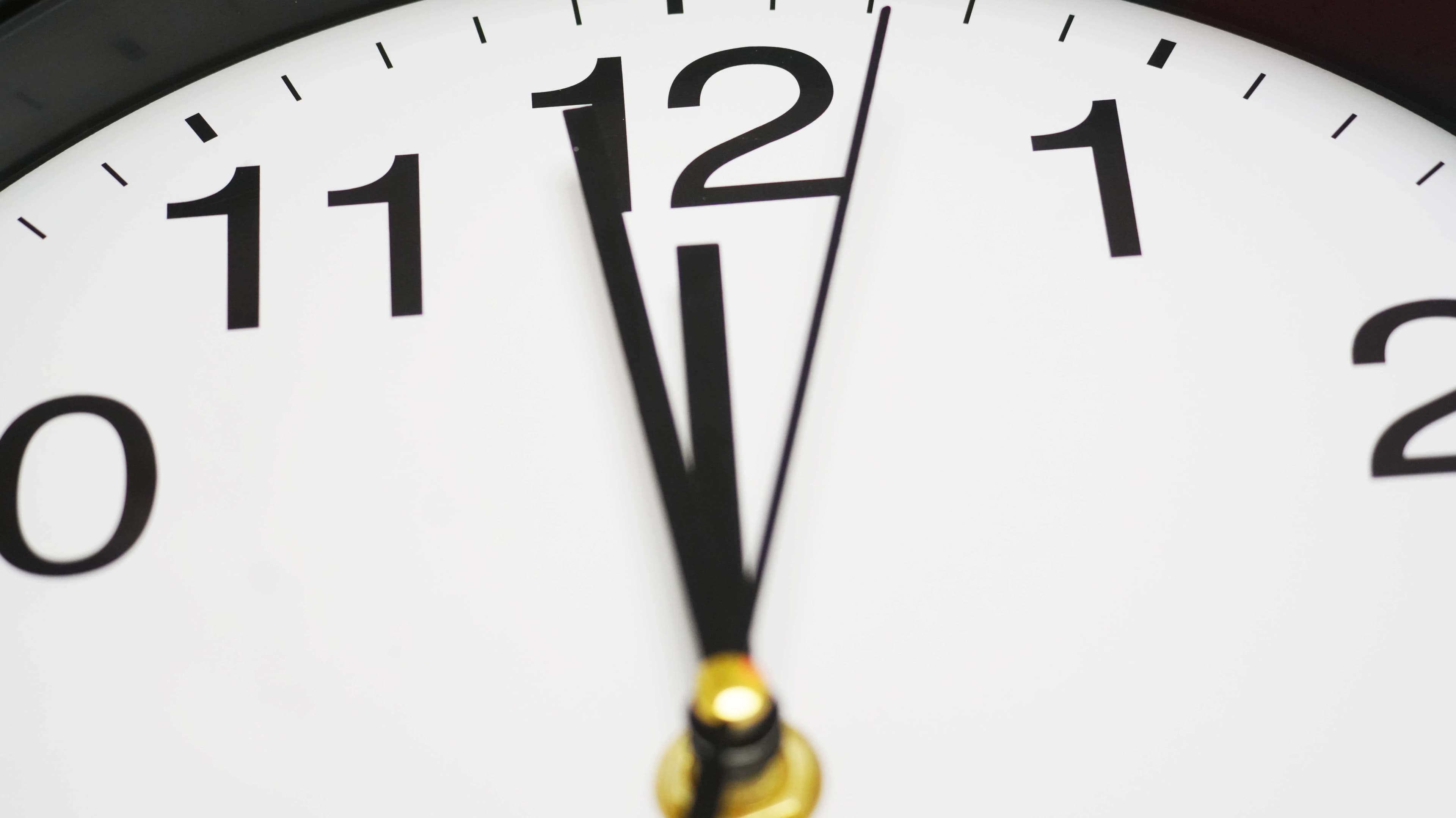 Close-up view of clock with its hands pointing at midnight, symbolizing  moment of transition urgency or new beginnings.