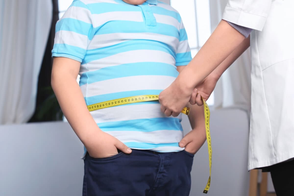 Doctor measuring overweight boy in clinic