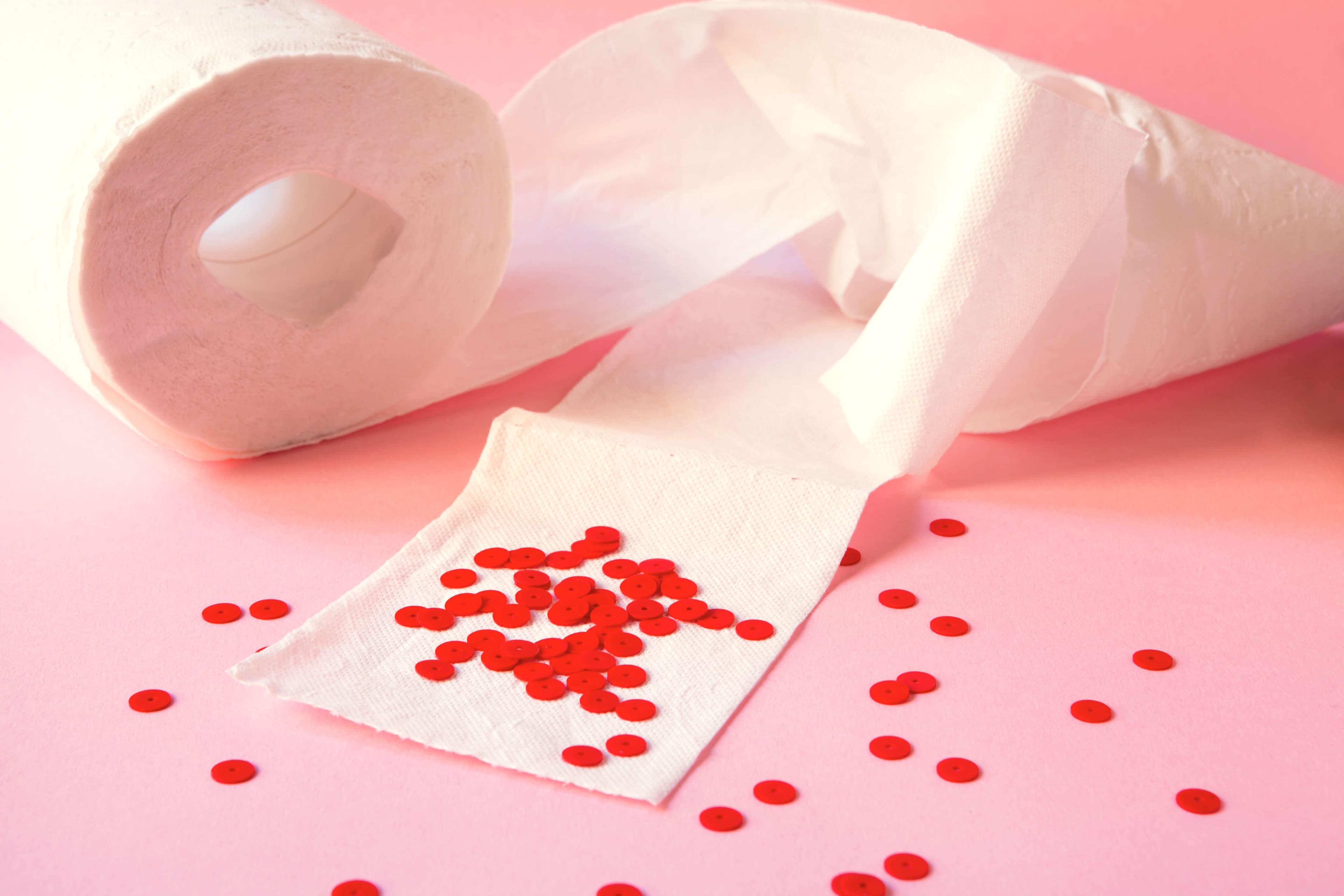 red beads as blood drops on soft white toilet paper