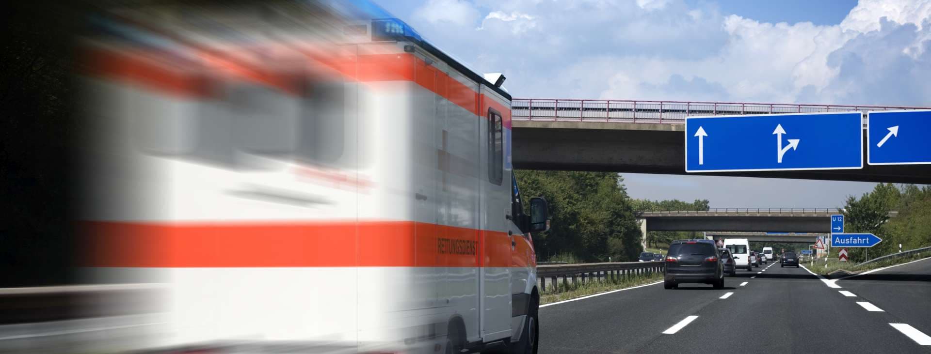 Speeding German ambulance on the highway, motion blur, all identificable logos and numbers have been removed carefully. The german word "Rettungsdienst" means "Ambulance"