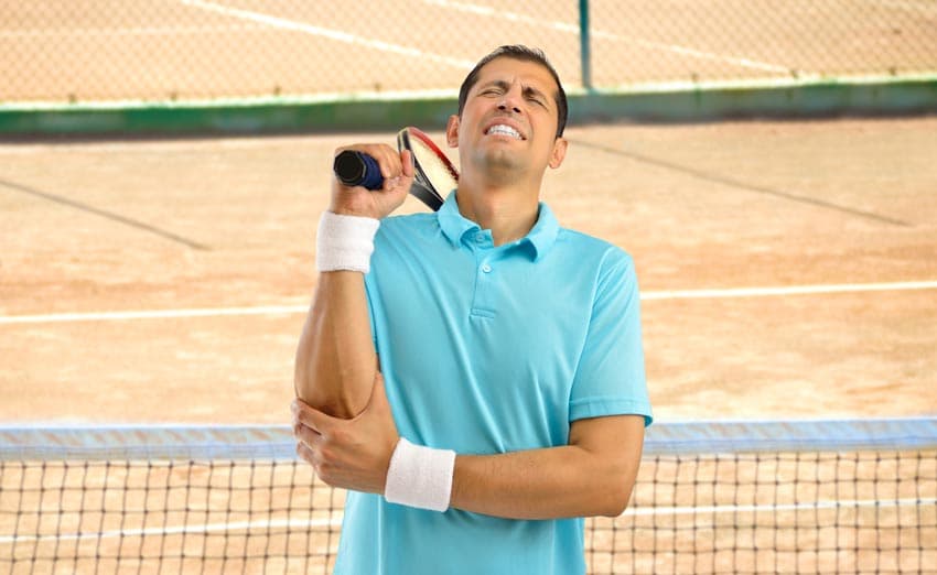 Tennisspieler hebt seinen Arm fest, weil er einen Tennisarm hat