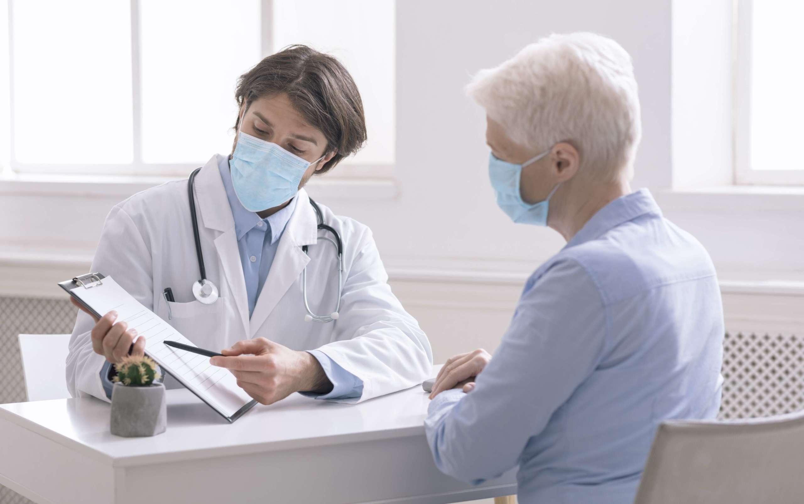Hausarzt zeigt der älteren Frau Analyseergebnisse während eines präventiven Besuchs