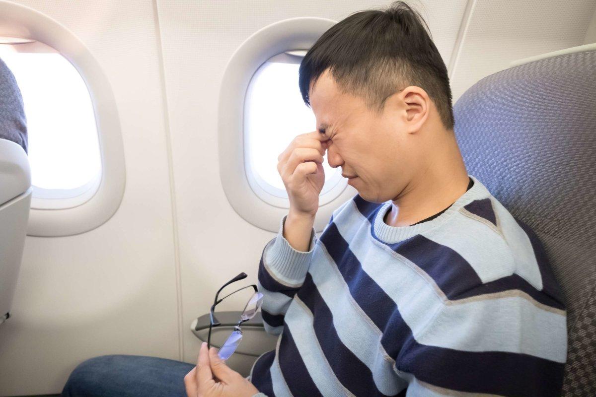 man feel eye pain in the airplane