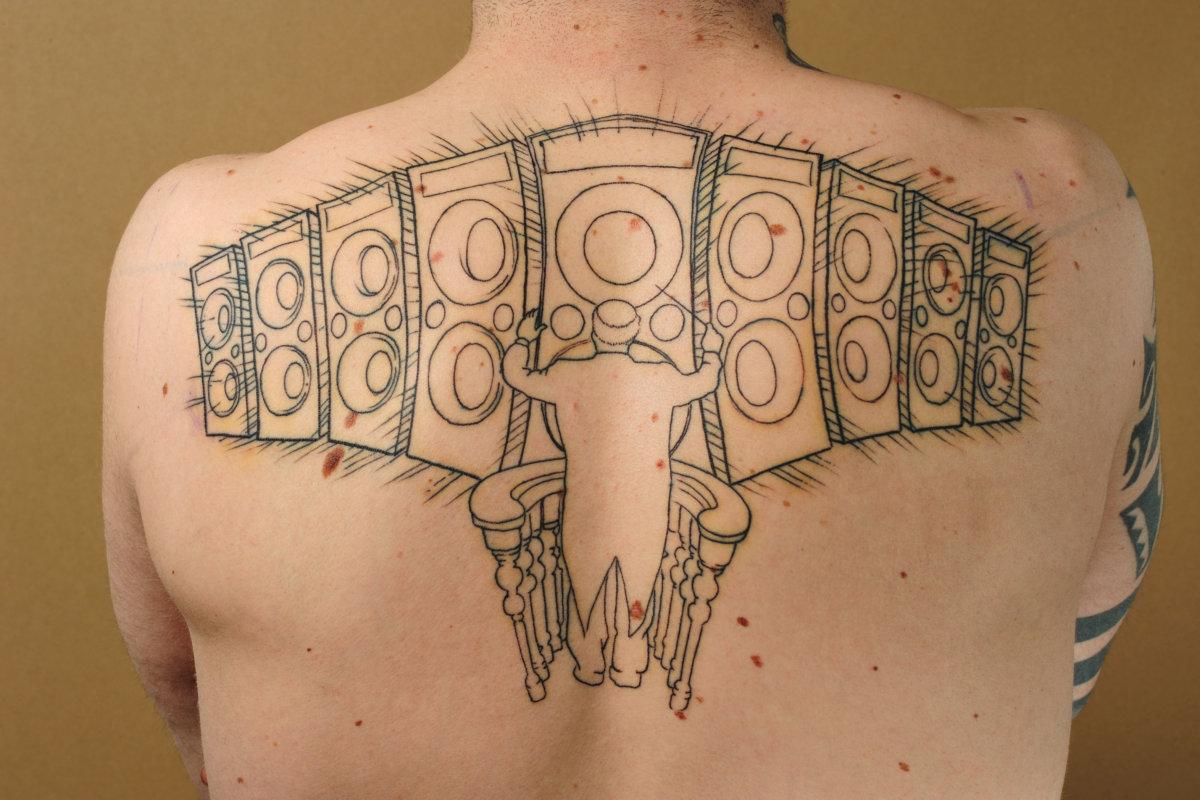 orchestra conductor and speakers tattooed on the back