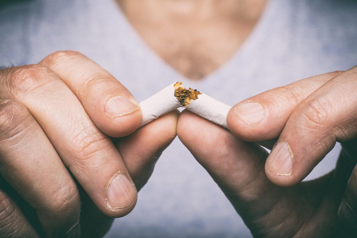 Mit dem Rauchen aufhören - männliche Hand zerdrückt Zigarette