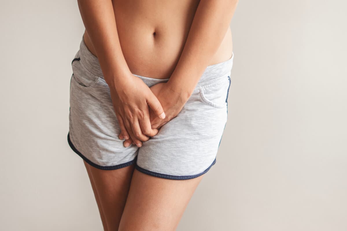 A woman holding her groin